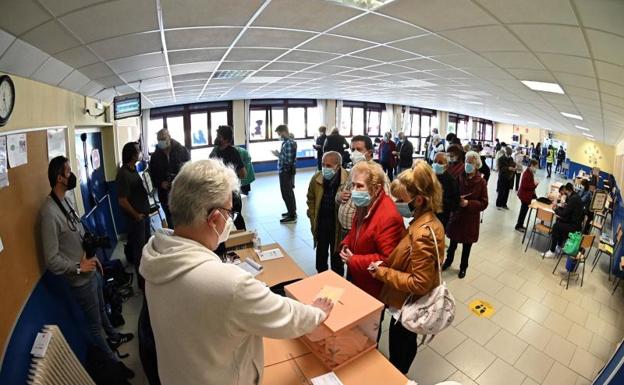 otantes ejercen su derecho al voto en el Colegio Pinar del Rey en Madrid/Efe