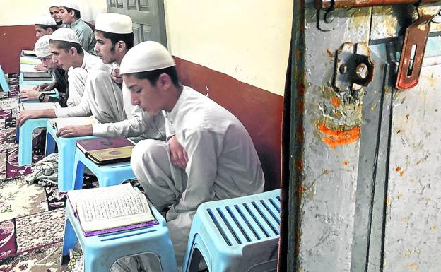 Un grupo de niños intenta memorizar el Coran en un aula de la madrasa.
