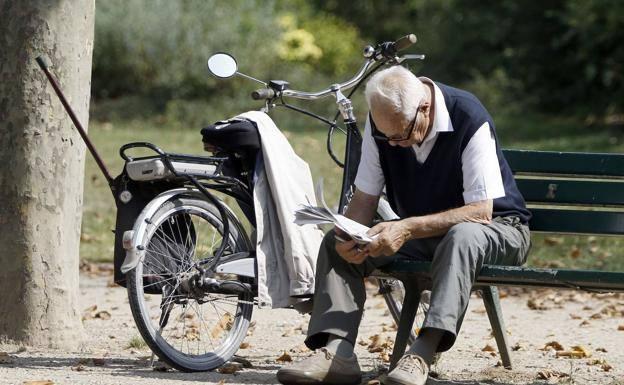 Un jubilado lee el periódico en un parque. /r. c.