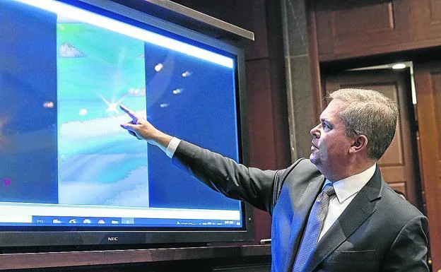 Scott Bray, deputy director of US Naval Intelligence, shows video of an unidentified aerial phenomenon on Capitol Hill. 