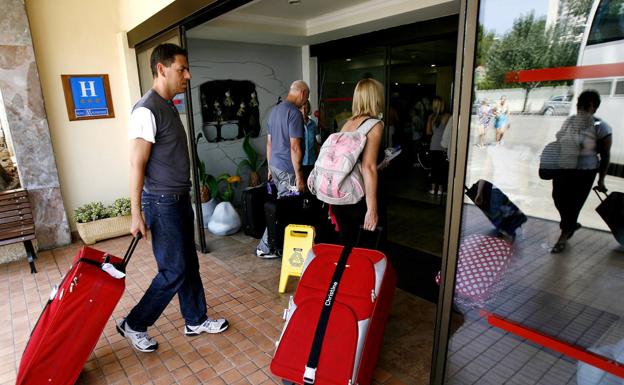 Tourists arrive at a hotel in Calviá, on the island of Mallorca. 