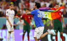 Un espontáneo salta al campo con una bandera arcoíris durante el Portugal-Uruguay
